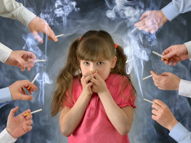 Smoking in front of the child kid .A little girl covers her nose from tobacco smoke.Conceptual photography.